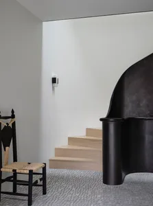 A modern minimalist staircase with wooden steps and a simple, clean design.