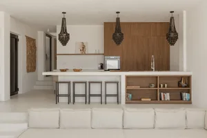 Interior design featuring a modern, open-plan living space with neutral-toned metal and wood furniture and decor.