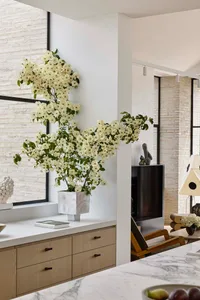 Modern interior space featuring minimalist design, marble countertops, and white brick walls.