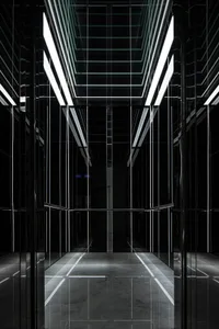 An empty minimalist lobby with black steel walls and floor.