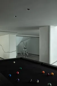 Modern game room with a metallic ball pool table.