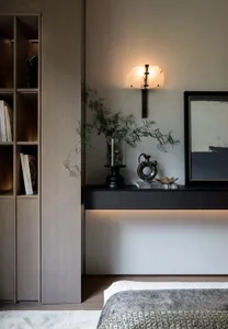 Minimalist bedroom with metal plant holder, concrete floor lamp, and concrete flooring.