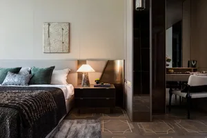 A modern bedroom featuring mixed-media decor and a geometric design floor.