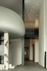 Modern minimalist entrance hall with concrete walls and ceiling lights