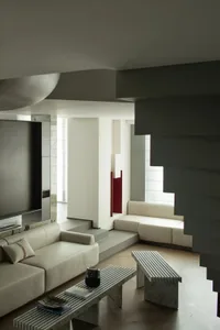 Minimalist living room with concrete furniture and clean lines.