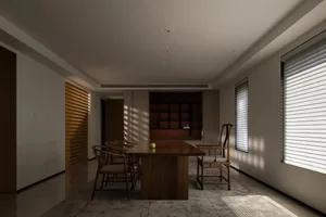 Modern minimalist dining room features wooden table and chairs, creating a clean and elegant space.
