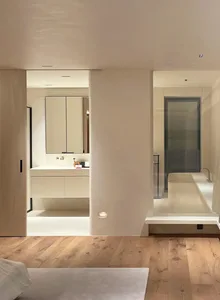 Modern minimalist bathroom with white walls and modern fixtures.