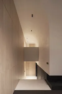 Modern interior design featuring a hallway with minimalist lighting and wood materials.