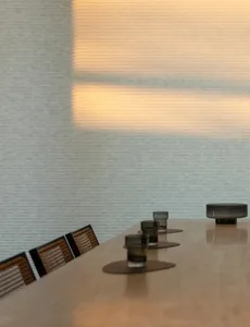 Modern dining room with smoked glass decorations on a sleek marble table.