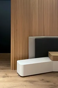 Modern interior space featuring wooden panels and white seating in a contemporary design