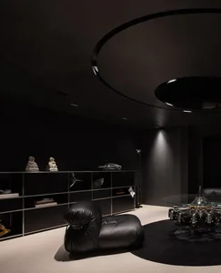 Modern living room featuring sleek, black metallic furniture and minimalistic decor.