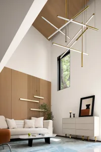 A modern living room featuring minimalist design, white sofa, brass lighting fixtures, and a large window.