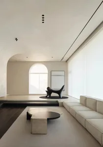 A modern minimalist living room featuring white and black elements.