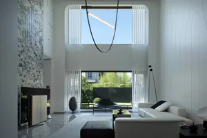 Modern minimalist residential interior with glass and marble finishes.