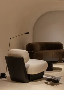 Modern living room with textured fabric seating and sleek lighting.