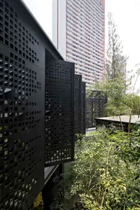 Urban rooftop with modern black perforated metal grid for greenery