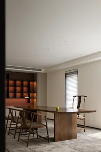 A modern dining room with wooden furniture and minimalist decor.