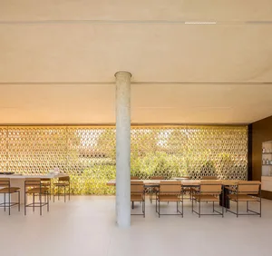 Modern kitchen interior with cement walls, minimalist design, and open layout.