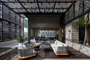 A modern living room with concrete and glass walls and furnishings.