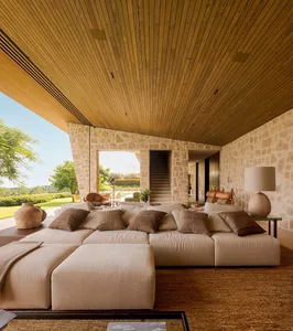 A modern living room with stone walls and wood accents.