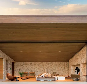 Modern living room with wooden ceiling, stone walls, and furniture.