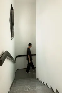 A minimalist interior space featuring a concrete staircase.