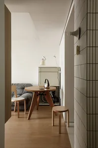 A minimalist interior design featuring a wooden table with a simple, modern design.