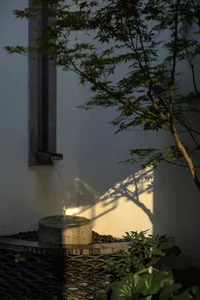 A minimalist water feature made of stone with flowing water.