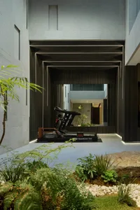 Modern gym area with metal frame, glass wall, and stone floor