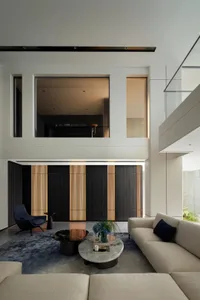 A modern interior design featuring a concrete living room with minimalist furniture and a large window.
