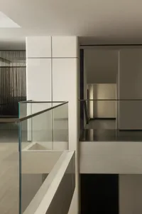 Modern interior with glass walls and stairs in a minimalist design.