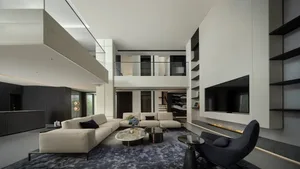 Contemporary minimalist living room with white couches, coffee tables, and a large flat-screen television in a high-ceiling m