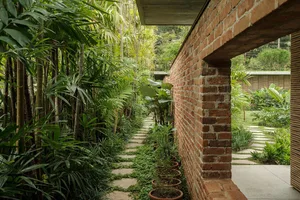 A minimalist outdoor landscape featuring mixed materials and greenery.