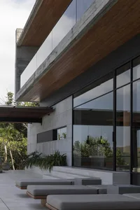 A modern house with a concrete facade and large windows.