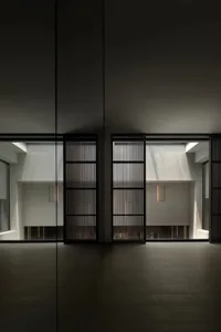A minimalist interior featuring wood, concrete, and glass materials.