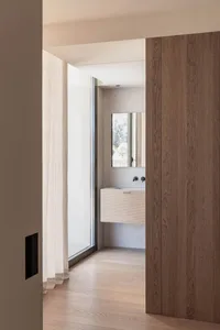 Modern minimalist bathroom featuring wood and concrete elements.