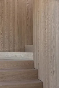 Modern, minimalist wooden staircase with a clean, geometric design.