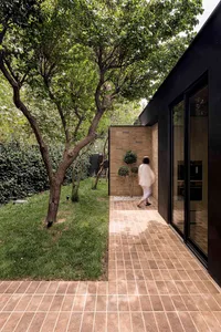 A modern exterior featuring brick, glass, and concrete materials.