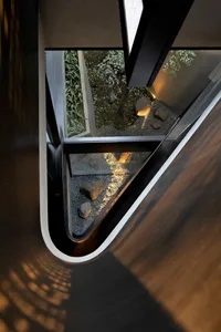 A modern concrete garden with glass walls.