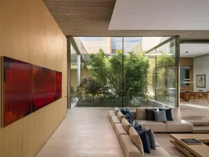 Modern interior design featuring wooden furniture and large windows.