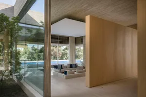 Modern living room featuring concrete and wooden elements.