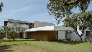 A modern residential exterior featuring minimalist design with a concrete facade.