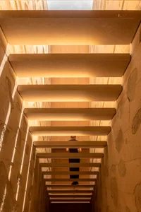 A modern interior space with a staircase made of concrete.