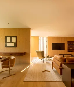 Modern living room with wooden walls and minimalist design.