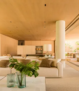 Modern minimalist living room with wooden furniture and white accents.