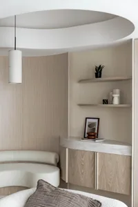 A modern bedroom featuring wood-paneled walls and a concrete shelf, with a hanging lamp and decorative objects on the shelf.