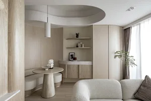 A modern minimalist living room with wood paneled walls and a curved seating area.