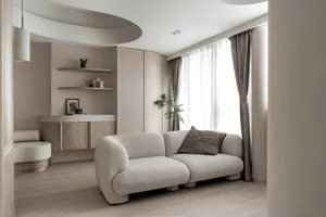 Modern living room with neutral-toned furniture and minimalist design.