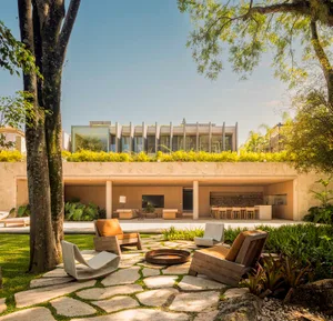 Modern residential exterior with concrete roof and landscaped garden
