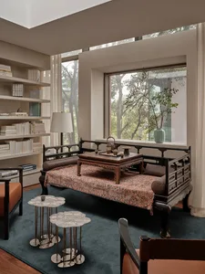 Traditional-style living room with couch, carpet, and wooden coffee table.